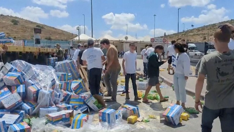 Sejumlah warga Israel memblokir truk bantuan yang menuju Gaza dan merusak serta menginjak paket makanan yang dibawa pada Senin (13/5/2024). Dari kemasannya, terlihat bahwa paket makanan tersebut termasuk produk seperti Indomie yang dikirim ke Gaza. (Tangkapan Layar Video Reuters/KAN2COME)