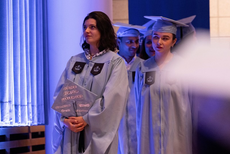ISRAEL-PALESTINIANS/USA A student holds up her graduation hat with a message supporting her colleagues after receiving a diploma during a graduation ceremony at Columbia University Journalism School, during the ongoing conflict between Israel and the Palestinian Islamist group Hamas, in New York City, U.S., May 15, 2024. REUTERS/Caitlin Ochs
