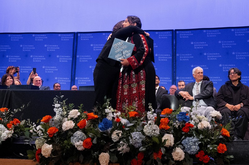 A student holds up her graduation hat with a message supporting her colleagues after receiving a diploma during a graduation ceremony at Columbia University Journalism School, during the ongoing conflict between Israel and the Palestinian Islamist group Hamas, in New York City, U.S., May 15, 2024.  REUTERS/Caitlin Ochs
