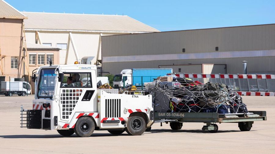 People line up as civil guards, police officers and sailors firefighters board a plane of the French Air Force at Istres military airbase after France declared a state of emergency to regain control of events in New Caledonia, near Marseille, France, May 16, 2024. REUTERS/Manon Cruz REFILE - CORRECTING FROM 