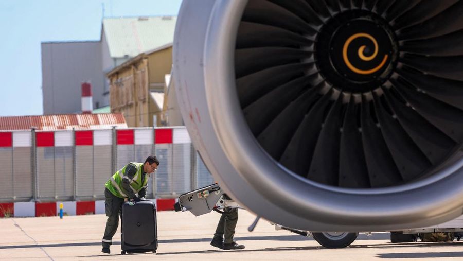 People line up as civil guards, police officers and sailors firefighters board a plane of the French Air Force at Istres military airbase after France declared a state of emergency to regain control of events in New Caledonia, near Marseille, France, May 16, 2024. REUTERS/Manon Cruz REFILE - CORRECTING FROM 