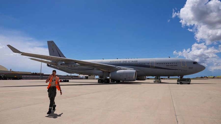 A man walks near a plane at Istres military airbase after France declared a state of emergency to regain control of events in New Caledonia, near Marseille, France, May 16, 2024. REUTERS/Manon Cruz