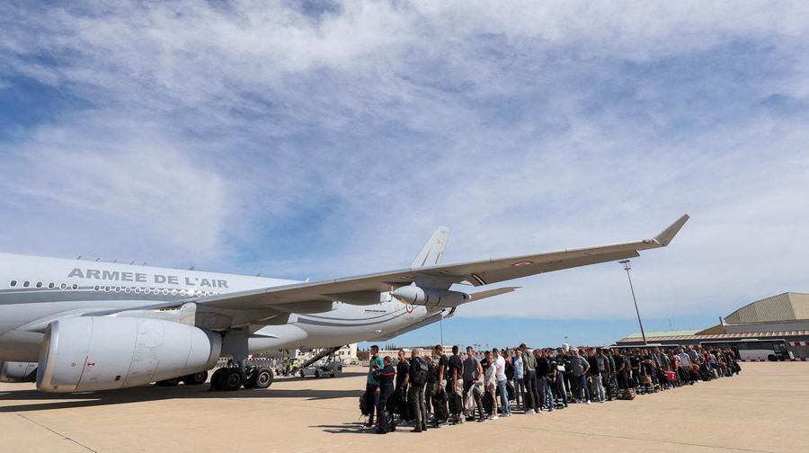 People line up as civil guards, police officers and sailors firefighters board a plane of the French Air Force at Istres military airbase after France declared a state of emergency to regain control of events in New Caledonia, near Marseille, France, May 16, 2024. REUTERS/Manon Cruz REFILE - CORRECTING FROM 