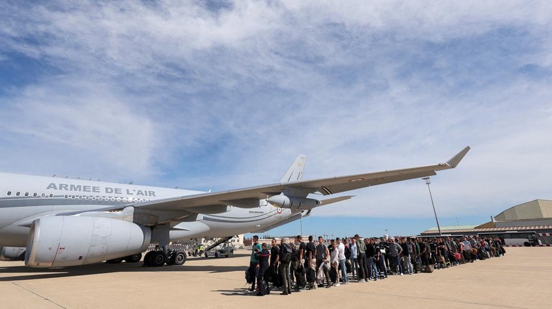 People line up as civil guards, police officers and sailors firefighters board a plane of the French Air Force at Istres military airbase after France declared a state of emergency to regain control of events in New Caledonia, near Marseille, France, May 16, 2024. REUTERS/Manon Cruz REFILE - CORRECTING FROM 