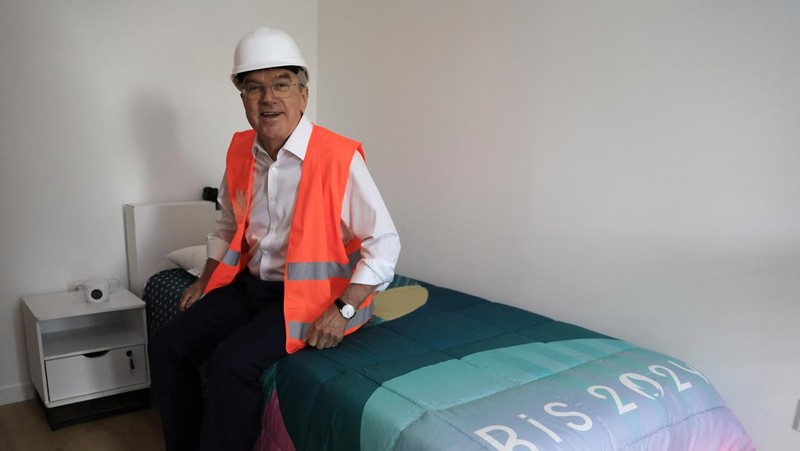 International Olympic Committee (IOC) president Thomas Bach enters a room as he visits the Athletes' village in Saint-Ouen-sur-Seine, outside Paris, Tuesday, July 25, 2023. (Pascal Rossignol/Pool via AP)