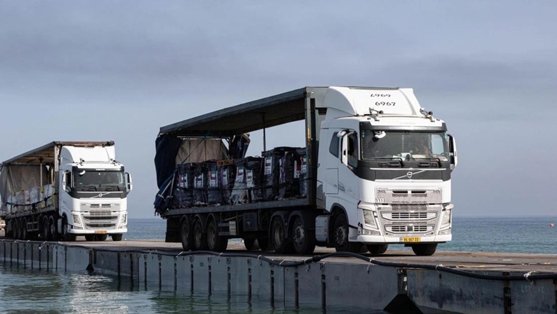 The image provided by U.S, Central Command, shows U.S. Army soldiers assigned to the 7th Transportation Brigade (Expeditionary), U.S. Navy sailors assigned to Amphibious Construction Battalion 1, and Israel Defense Forces placing the Trident Pier on the coast of Gaza Strip on Thursday, May 16, 2024. The temporary pier is part of the Joint Logistics Over-the-Shore capability. The U.S. military finished installing the floating pier on Thursday, with officials poised to begin ferrying badly needed humanitarian aid into the enclave besieged over seven months of intense fighting in the Israel-Hamas war. (U.S. Central Command via AP)