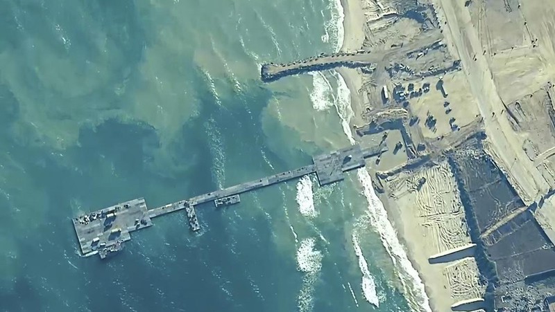 The image provided by U.S, Central Command, shows U.S. Army soldiers assigned to the 7th Transportation Brigade (Expeditionary), U.S. Navy sailors assigned to Amphibious Construction Battalion 1, and Israel Defense Forces placing the Trident Pier on the coast of Gaza Strip on Thursday, May 16, 2024. The temporary pier is part of the Joint Logistics Over-the-Shore capability. The U.S. military finished installing the floating pier on Thursday, with officials poised to begin ferrying badly needed humanitarian aid into the enclave besieged over seven months of intense fighting in the Israel-Hamas war. (U.S. Central Command via AP)