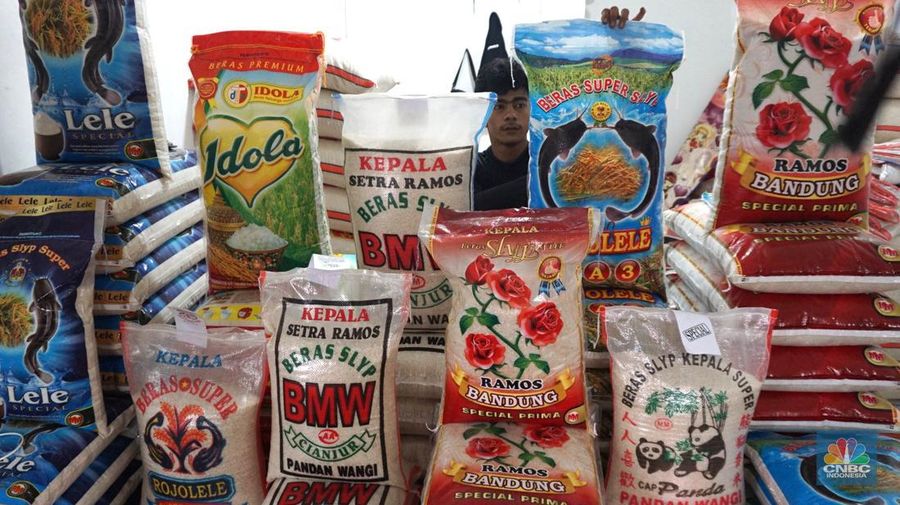 Petugas menata beras di pertokoan kawasan Pasar Minggu, Jakarta, Rabu, (22/5). Badan Pangan Nasional (Bapanas) mengeluarkan kebijakan relaksasi Harga Eceran Tertinggi (HET) untuk beras premium sebesar Rp 1.000 per kilogram (kg). Relaksasi HET beras premium ini diberlakukan sementara mulai 10 Maret sampai 23 Maret, menyasar 8 wilayah. (CNBC Indonesia/Muhammad Sabki)