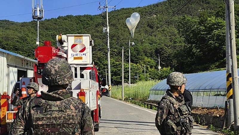 Militer Korea Selatan pada Rabu (29/5) memperingatkan warga yang tinggal di perbatasan dengan Korea Utara untuk waspada usai balon-balon yang membawa sampah dan kotoran mendarat di wilayah Korsel. Sebelumnya, militer Korsel menunjukkan sepasang balon putih yang mengembang dengan kantong sampah. (Jeonbuk Fire Headquarters via AP)