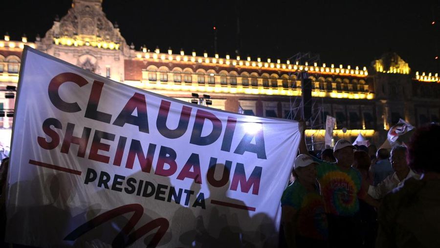 People hold a banner reading 'President Claudia Sheinbaum' after Mexico's ruling Morena party declared Claudia Sheinbaum the winner of the presidential election, at Zocalo Square in downtown Mexico City, Mexico June 2, 2024. REUTERS/Mahe Elipe