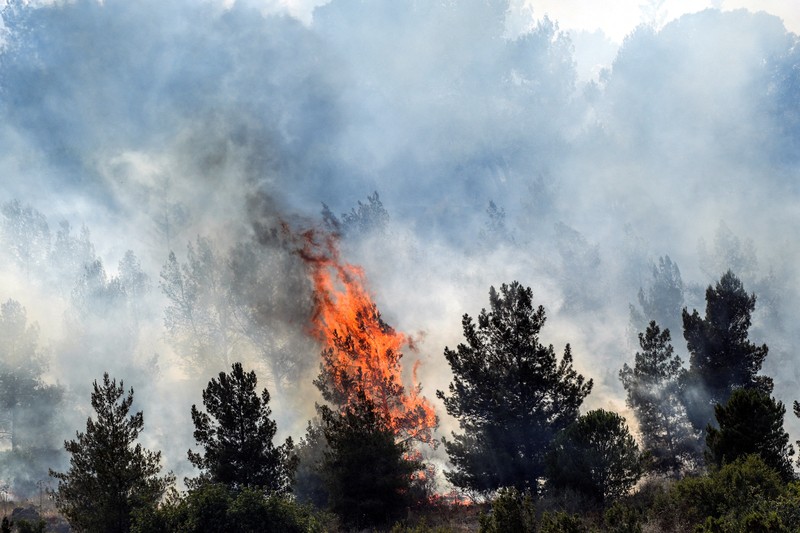 Smoke and fire covers the area following rocket attacks from Lebanon, amid ongoing cross-border hostilities between Hezbollah and Israeli forces, near Kiryat Shmona, Israel, close to its border with Lebanon, June 3, 2024. REUTERS/Ayal Margolin ISRAEL OUT. NO COMMERCIAL OR EDITORIAL SALES IN ISRAEL