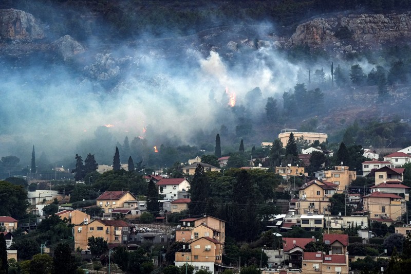 Smoke and fire covers the area following rocket attacks from Lebanon, amid ongoing cross-border hostilities between Hezbollah and Israeli forces, near Kiryat Shmona, Israel, close to its border with Lebanon, June 3, 2024. REUTERS/Ayal Margolin ISRAEL OUT. NO COMMERCIAL OR EDITORIAL SALES IN ISRAEL
