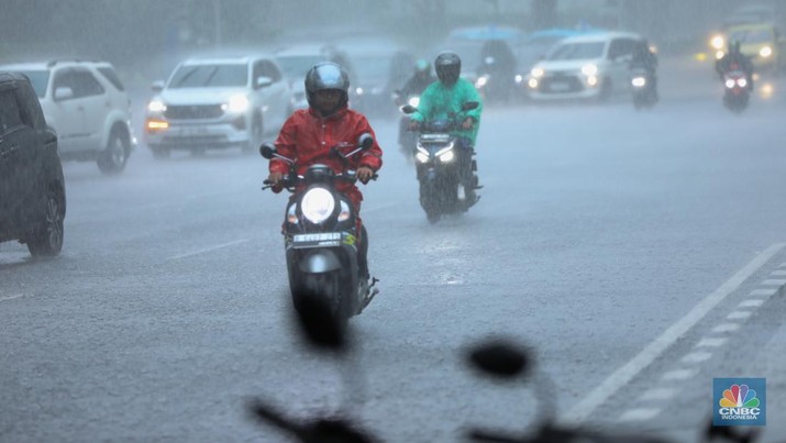 Sejumlah pengendara berteduh saat hujan deras dan angin kencang di kawasan Sudirman, Jakarta, Selasa (4/6/2024). (CNBC Indonesia/Tri Susilo)