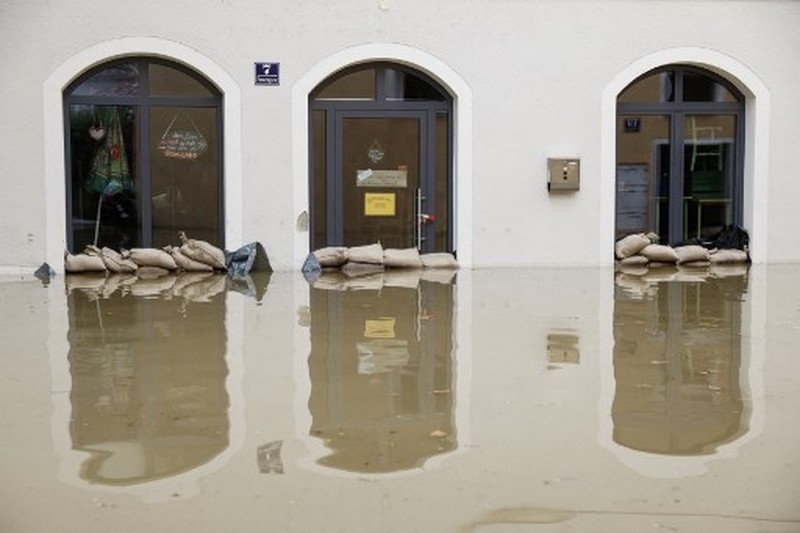 A gold selling shop is under water in a flooded street in the center of Passau in Bavaria, southern Germany, on June 4, 2024. Heavy rains from May 31, 2024 onwards have led to flooding across the southern German states of Baden-Wuerttemberg and Bavaria and that have claimed four lives so far. Thousands of people in these regions had to leave their homes. (Photo by Michaela STACHE / AFP)