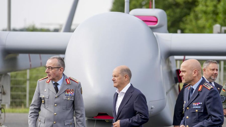 Kanselir Jerman Olaf Scholz, tengah, berjalan melewati drone Heron TP di International Air Show ILA di Berlin, Jerman, Rabu, 5 Juni 2024. (AP Photo/Ebrahim Noroozi)