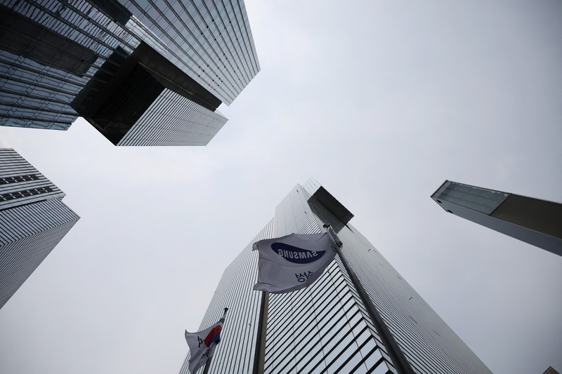 Members of National Samsung Electronics Union hold placards, which read 