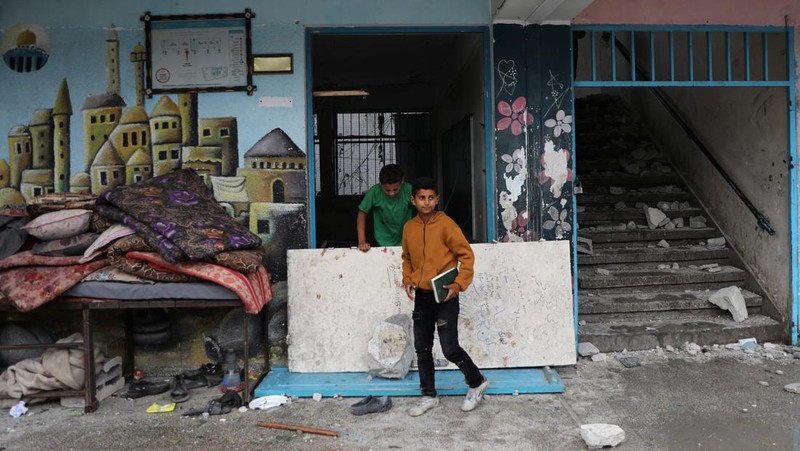 Warga Palestina memeriksa lokasi serangan Israel terhadap sekolah UNRWA yang menampung para pengungsi, di tengah konflik Israel-Hamas, di kamp pengungsi Nuseirat di Jalur Gaza tengah, 6 Juni 2024. (REUTERS/Abed Khaled)
