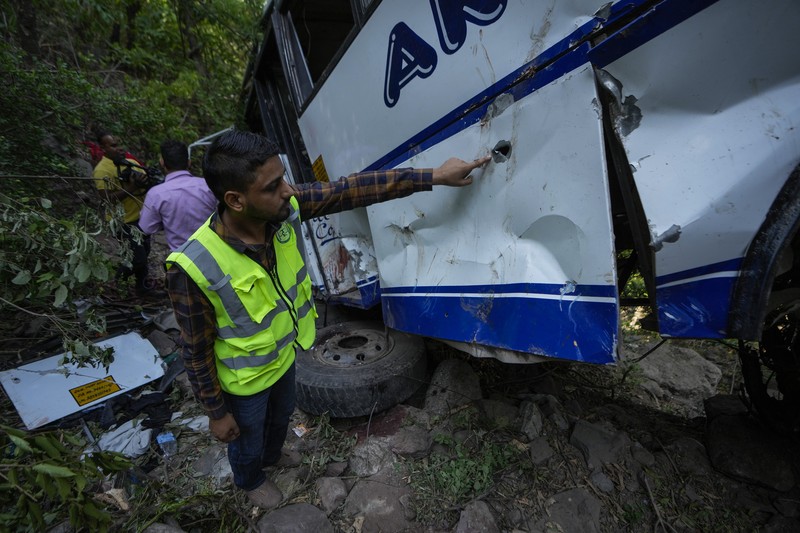 Petugas keamanan memeriksa sebuah bus yang jatuh ke jurang yang dalam pada hari Minggu setelah ditembaki oleh tersangka militan di distrik Reasi, Jammu dan Kashmir, Senin, 10 Juni 2024. Petugas keamanan memeriksa sebuah bus yang jatuh ke jurang yang dalam pada hari Minggu setelah ditembaki oleh tersangka militan di distrik Reasi, Jammu dan Kashmir, Senin, 10 Juni 2024. Bus itu membawa peziarah ke base camp kuil Hindu yang terkenal itu Mata Vaishno Devi saat diserang menewaskan sedikitnya sembilan orang. (AP Photo/Channi Anand)