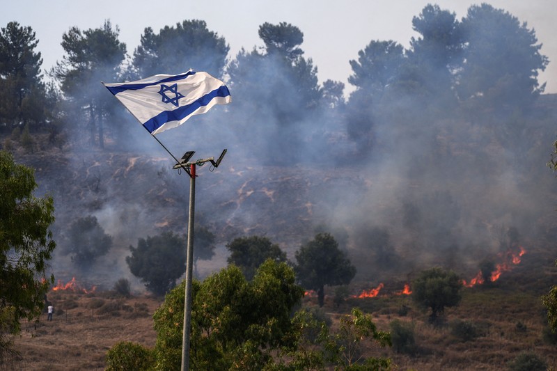 Tentara Israel berupaya memadamkan api yang membakar lahan hutan mereka setelah serangan rudal Hizbullah di pinggir jalan dekat perbatasan Israel dengan Lebanon, di Israel. (Photo by Jalaa MAREY / AFP) Tentara Israel berupaya memadamkan api yang membakar lahan hutan mereka setelah serangan rudal Hizbullah di pinggir jalan dekat perbatasan Israel dengan Lebanon, di Israel. (Photo by Jalaa MAREY / AFP)
