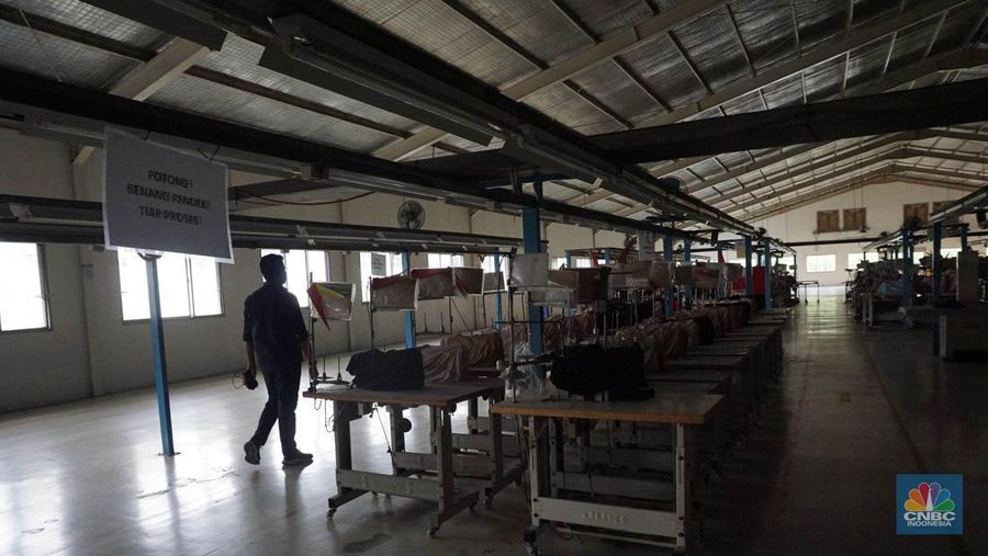 Suasana kondisi ribuan alat mesin jahit yang ditutup kain dan tidak terpakai pada salah satu pabrik garmen di kawasan Cilengsi, Kabupaten Bogor, Jawa Barat, Kamis (13/6/2024). (CNBC Indonesia/Muhammad Sabki)