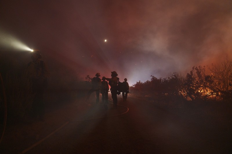 Firefighters work against the advancing Post Fire on Sunday, June 16, 2024, in Gorman, Calif. (AP Photo/Eric Thayer)