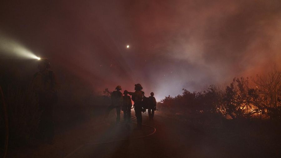 Firefighters work against the advancing Post Fire on Sunday, June 16, 2024, in Gorman, Calif. (AP Photo/Eric Thayer)