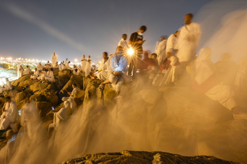 Saudi Arabia Hajj Muslim pilgrims use umbrellas to shade themselves from the sun as they gather outside Nimrah Mosque to offer the noon prayers in Arafat, on the second day of the annual hajj pilgrimage, near the holy city of Mecca, Saudi Arabia, Saturday, June 15, 2024. Masses of Muslims gathered at the sacred hill of Mount Arafat in Saudi Arabia for worship and reflection on the second day of the Hajj pilgrimage. The ritual at Mount Arafat, known as the hill of mercy, is considered the peak of the Hajj. It's often the most memorable event for pilgrims, who stand shoulder to shoulder, asking God for mercy, blessings, prosperity and good health. Hajj is one of the largest religious gatherings on earth.(AP Photo/Rafiq Maqbool)