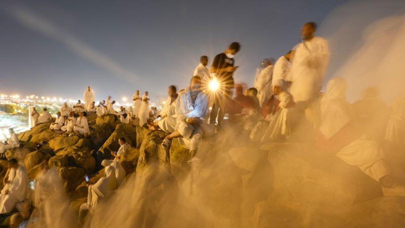 Muslim pilgrims gather at top of the rocky hill known as the Mountain of Mercy, on the Plain of Arafat, during the annual Hajj pilgrimage, near the holy city of Mecca, Saudi Arabia, Saturday, June 15, 2024. Masses of Muslims gathered at the sacred hill of Mount Arafat in Saudi Arabia for worship and reflection on the second day of the Hajj pilgrimage. The ritual at Mount Arafat, known as the hill of mercy, is considered the peak of the Hajj. It's often the most memorable event for pilgrims, who stand shoulder to shoulder, asking God for mercy, blessings, prosperity and good health. Hajj is one of the largest religious gatherings on earth. (AP Photo/Rafiq Maqbool)