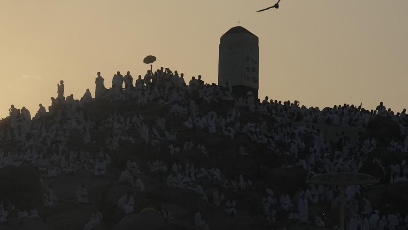 Muslim pilgrims gather at top of the rocky hill known as the Mountain of Mercy, on the Plain of Arafat, during the annual Hajj pilgrimage, near the holy city of Mecca, Saudi Arabia, Saturday, June 15, 2024. Masses of Muslims gathered at the sacred hill of Mount Arafat in Saudi Arabia for worship and reflection on the second day of the Hajj pilgrimage. The ritual at Mount Arafat, known as the hill of mercy, is considered the peak of the Hajj. It's often the most memorable event for pilgrims, who stand shoulder to shoulder, asking God for mercy, blessings, prosperity and good health. Hajj is one of the largest religious gatherings on earth. (AP Photo/Rafiq Maqbool)