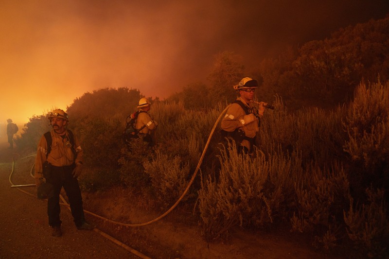 Firefighters work against the advancing Post Fire on Sunday, June 16, 2024, in Gorman, Calif. (AP Photo/Eric Thayer)