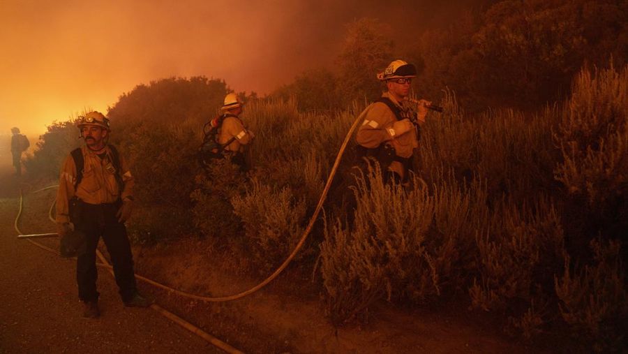 Firefighters work against the advancing Post Fire on Sunday, June 16, 2024, in Gorman, Calif. (AP Photo/Eric Thayer)