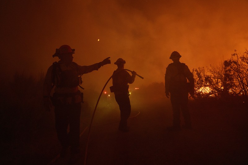 Firefighters work against the advancing Post Fire on Sunday, June 16, 2024, in Gorman, Calif. (AP Photo/Eric Thayer)