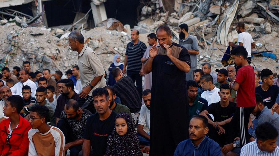 Palestinians hold Eid al-Adha prayers by the ruins of the Al-Rahma mosque destroyed by Israeli air strikes, amid the Israel-Hamas conflict, in Khan Younis, in the southern Gaza Strip, June 16, 2024. REUTERS/Mohammed Salem