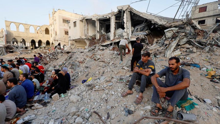 Palestinians hold Eid al-Adha prayers by the ruins of al-Al Rahma mosque destroyed by Israeli air strikes, amid the Israel-Hamas conflict, in Khan Younis, in the southern Gaza Strip, June 16, 2024. REUTERS/Mohammed Salem