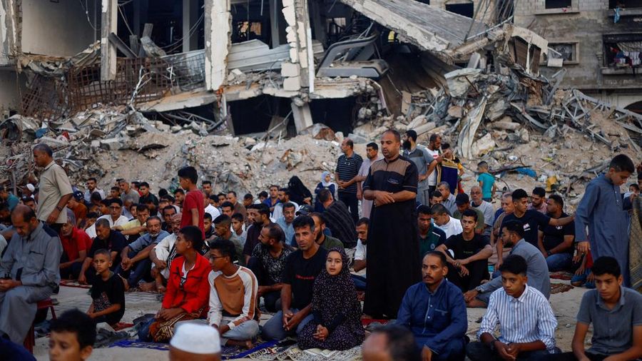 Palestinians hold Eid al-Adha prayers by the ruins of the Al-Rahma mosque destroyed by Israeli air strikes, amid the Israel-Hamas conflict, in Khan Younis, in the southern Gaza Strip, June 16, 2024. REUTERS/Mohammed Salem