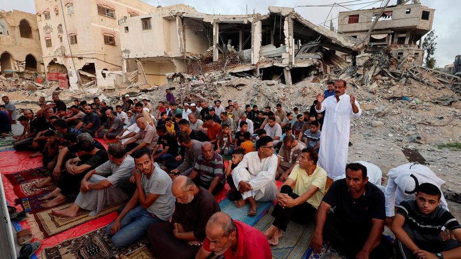 Palestinians hold Eid al-Adha prayers by the ruins of the Al-Rahma mosque destroyed by Israeli air strikes, amid the Israel-Hamas conflict, in Khan Younis, in the southern Gaza Strip, June 16, 2024. REUTERS/Mohammed Salem