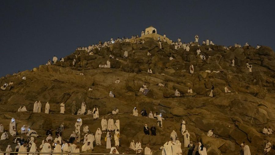 Muslim pilgrims gather at top of the rocky hill known as the Mountain of Mercy, on the Plain of Arafat, during the annual Hajj pilgrimage, near the holy city of Mecca, Saudi Arabia, Saturday, June 15, 2024. Masses of Muslims gathered at the sacred hill of Mount Arafat in Saudi Arabia for worship and reflection on the second day of the Hajj pilgrimage. The ritual at Mount Arafat, known as the hill of mercy, is considered the peak of the Hajj. It's often the most memorable event for pilgrims, who stand shoulder to shoulder, asking God for mercy, blessings, prosperity and good health. Hajj is one of the largest religious gatherings on earth. (AP Photo/Rafiq Maqbool)