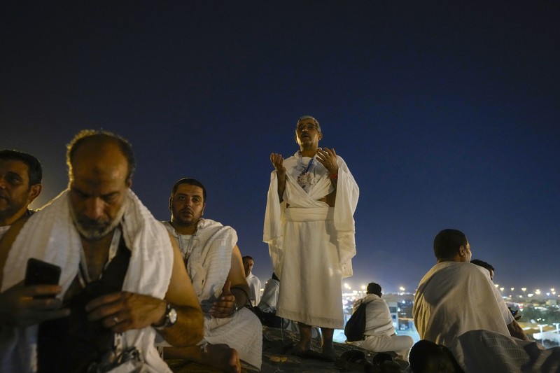 Muslim pilgrims use umbrellas to shade themselves from the sun as they gather outside Nimrah Mosque to offer the noon prayers in Arafat, on the second day of the annual hajj pilgrimage, near the holy city of Mecca, Saudi Arabia, Saturday, June 15, 2024. Masses of Muslims gathered at the sacred hill of Mount Arafat in Saudi Arabia for worship and reflection on the second day of the Hajj pilgrimage. The ritual at Mount Arafat, known as the hill of mercy, is considered the peak of the Hajj. It's often the most memorable event for pilgrims, who stand shoulder to shoulder, asking God for mercy, blessings, prosperity and good health. Hajj is one of the largest religious gatherings on earth.(AP Photo/Rafiq Maqbool)