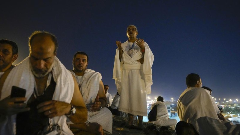 Muslim pilgrims gather at top of the rocky hill known as the Mountain of Mercy, on the Plain of Arafat, during the annual Hajj pilgrimage, near the holy city of Mecca, Saudi Arabia, Saturday, June 15, 2024. Masses of Muslims gathered at the sacred hill of Mount Arafat in Saudi Arabia for worship and reflection on the second day of the Hajj pilgrimage. The ritual at Mount Arafat, known as the hill of mercy, is considered the peak of the Hajj. It's often the most memorable event for pilgrims, who stand shoulder to shoulder, asking God for mercy, blessings, prosperity and good health. Hajj is one of the largest religious gatherings on earth. (AP Photo/Rafiq Maqbool)