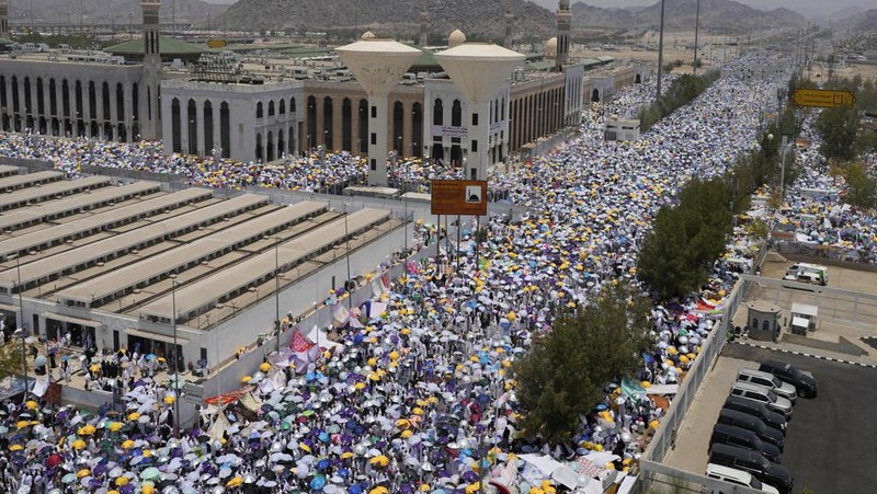 Muslim pilgrims gather at top of the rocky hill known as the Mountain of Mercy, on the Plain of Arafat, during the annual Hajj pilgrimage, near the holy city of Mecca, Saudi Arabia, Saturday, June 15, 2024. Masses of Muslims gathered at the sacred hill of Mount Arafat in Saudi Arabia for worship and reflection on the second day of the Hajj pilgrimage. The ritual at Mount Arafat, known as the hill of mercy, is considered the peak of the Hajj. It's often the most memorable event for pilgrims, who stand shoulder to shoulder, asking God for mercy, blessings, prosperity and good health. Hajj is one of the largest religious gatherings on earth. (AP Photo/Rafiq Maqbool)