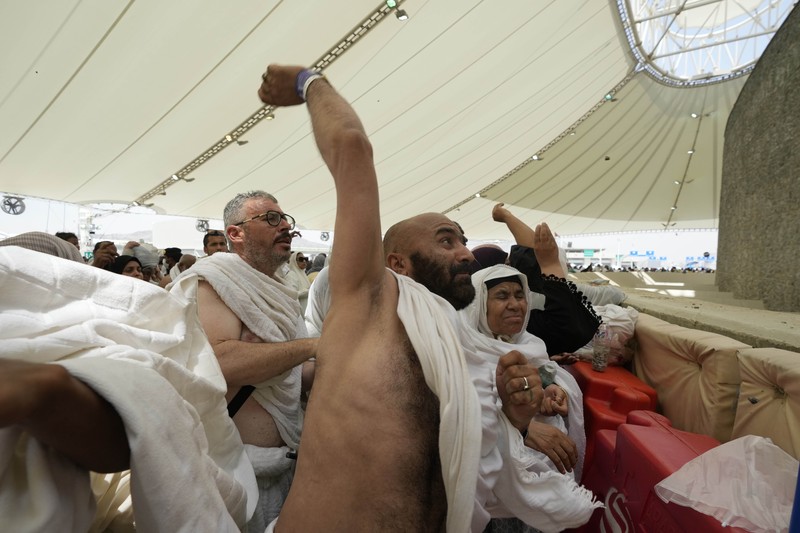 Saudi Arabia Hajj Muslim pilgrims arrive to cast stones at pillars in the symbolic stoning of the devil, the last rite of the annual hajj, in Mina, near the holy city of Mecca, Saudi Arabia, Sunday, June 16, 2024. The ritual marks the final days of the Hajj, or Islamic pilgrimage, and the start of the Eid al-Adha celebrations for Muslims around the world. (AP Photo/Rafiq Maqbool)