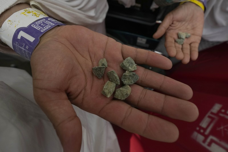 Muslim pilgrims arrive to cast stones at pillars in the symbolic stoning of the devil, the last rite of the annual hajj, in Mina, near the holy city of Mecca, Saudi Arabia, Sunday, June 16, 2024.  The ritual marks the final days of the Hajj, or Islamic pilgrimage, and the start of the Eid al-Adha celebrations for Muslims around the world. (AP Photo/Rafiq Maqbool)