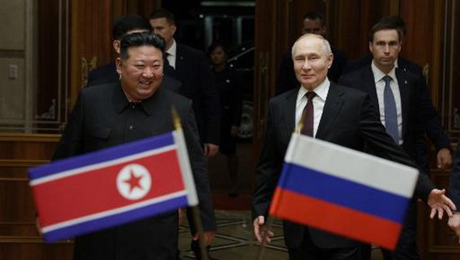 In this pool photograph distributed by the Russian state agency Sputnik, North Korea's leader Kim Jong Un (L) walks with Russian President Vladimir Putin during a welcoming ceremony upon Putin's arrival in Pyongyang, early on June 19, 2024. Russian President Vladimir Putin landed in North Korea early on June 19, the Kremlin said, kicking off a visit set to boost defence ties between the two nuclear-armed countries as Moscow pursues its war in Ukraine. (Photo by Gavriil GRIGOROV / POOL / AFP)