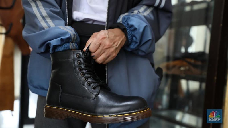 Pekerja menyelesaikan pembuatan pola alas kaki sepatu kulit di workshop Flavio Boston di kawasan Jakarta, Rabu (19/6/2024). (CNBC Indonesia/Tri Susilo)