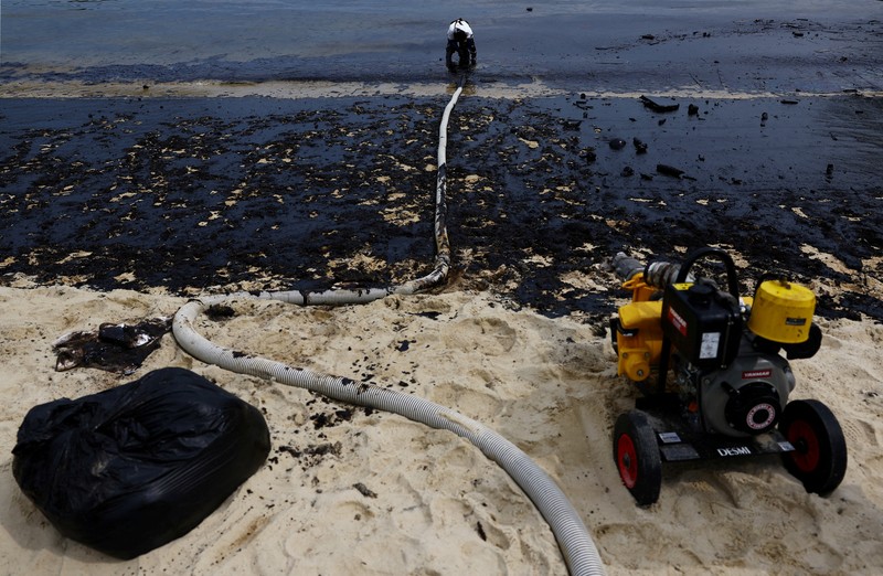 Pembersihan tumpahan minyak di Pantai Tanjong, Sentosa, Singapura, Selasa (18/6/2024). (REUTERS/Edgar Su) Pembersihan tumpahan minyak di Pantai Tanjong, Sentosa, Singapura, Selasa (18/6/2024). (REUTERS/Edgar Su)
