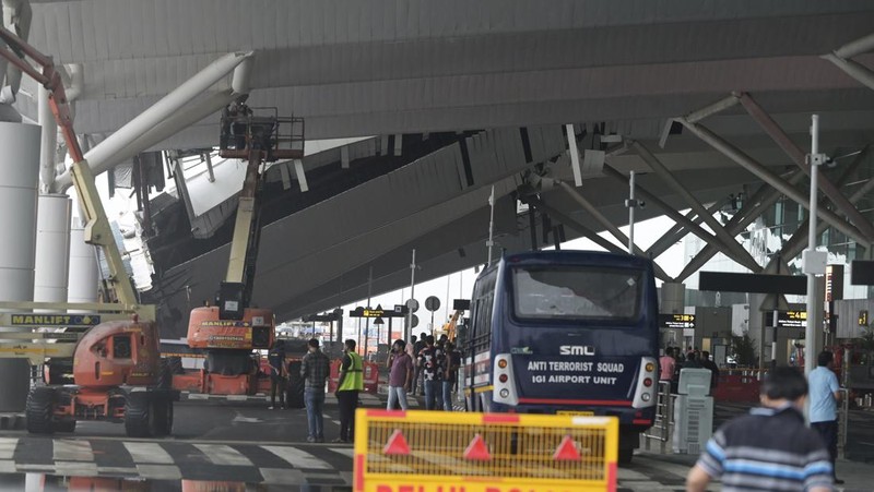 Seorang kru memeriksa kerusakan pada bagian kanopi terminal keberangkatan di Bandara Internasional Indira Gandhi New Delhi yang runtuh akibat hujan lebat sebelum musim hujan di New Delhi, India, Jumat, 28 Juni 2024. (AP Photo)