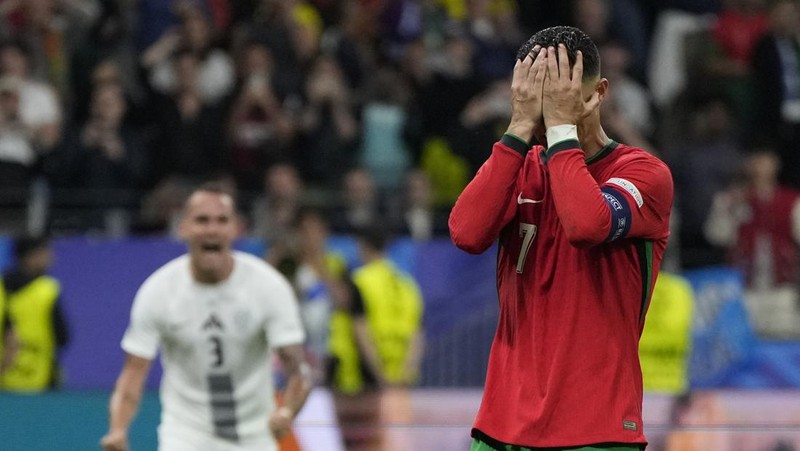 Reaksi pemain Portugal Cristiano Ronaldo setelah gagal mencetak penalti pada pertandingan babak enam belas besar antara Portugal dan Slovenia pada turnamen sepak bola Euro 2024 di Frankfurt, Jerman, Senin, 1 Juli 2024. (AP Photo/Matthias Schrader)