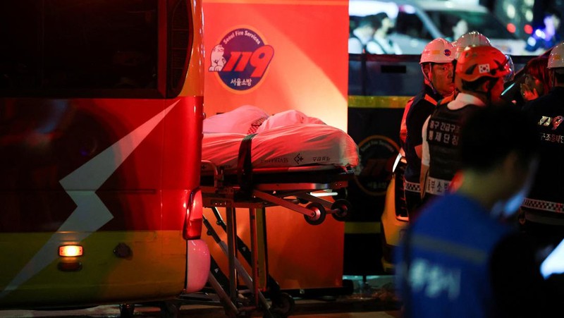 Polisi dan tim penyelamat berdiri di samping mobil yang terlibat dalam kecelakaan yang mengakibatkan beberapa orang tewas dan terluka di pusat kota Seoul, Korea Selatan 1 Juli 2024. (REUTERS/Kim Hong-Ji)