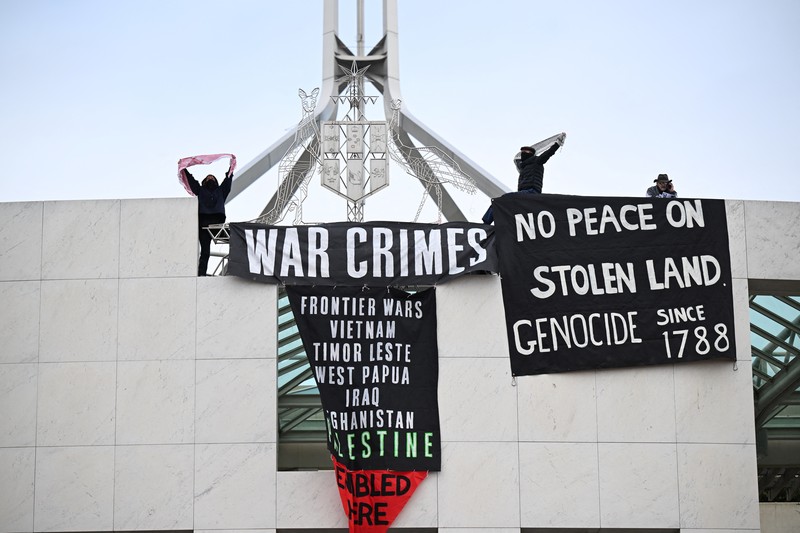 Pengunjuk rasa pro-Palestina menggantung spanduk di puncak Gedung Parlemen di Canberra, Australia, 4 Juli 2024. Pengunjuk rasa pro-Palestina menggantung spanduk di puncak Gedung Parlemen di Canberra, Australia, 4 Juli 2024. (AAP/Lukas Coch via REUTERS)