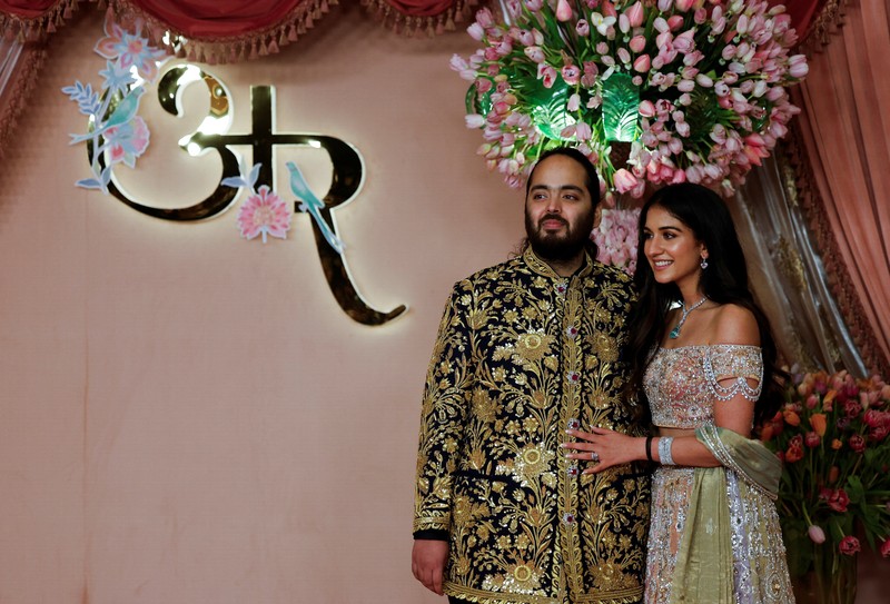 Anant Ambani, son of businessman Mukesh Ambani, poses with his fiance Radhika Merchant on the red carpet during the sangeet ceremony at Jio World Centre, Mumbai, India, July 5, 2024. REUTERS/Francis Mascarenhas